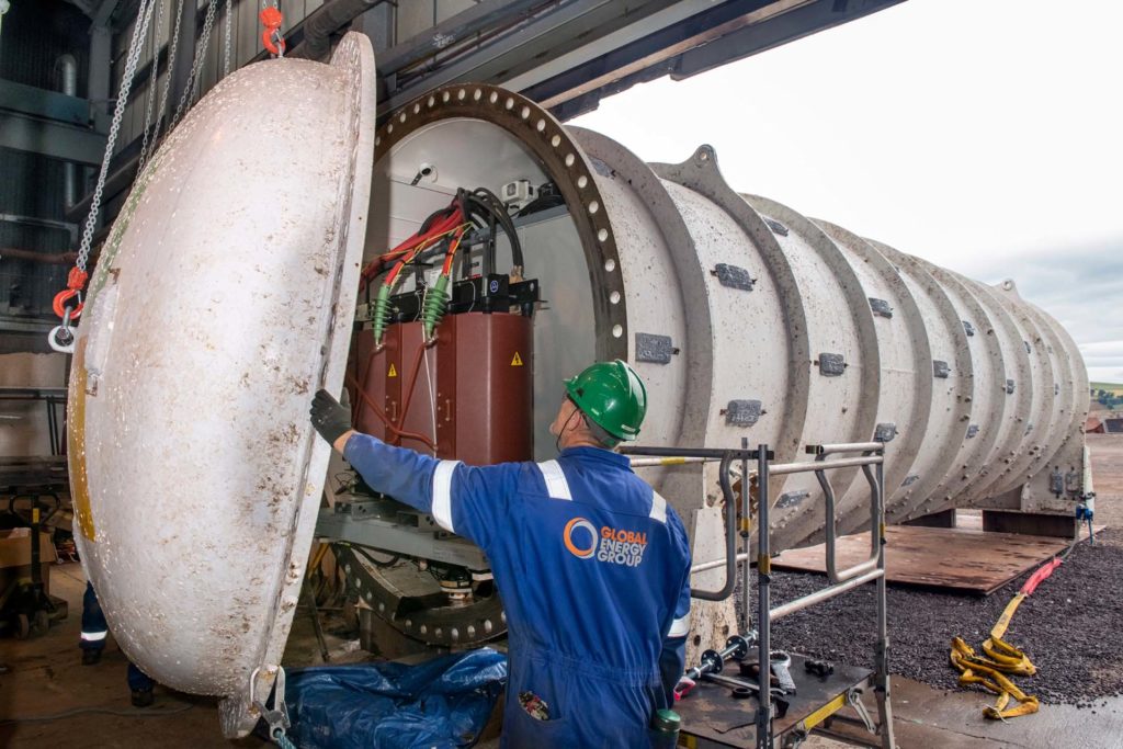 A person helps remove the end cap of the Northern Isles datacenter