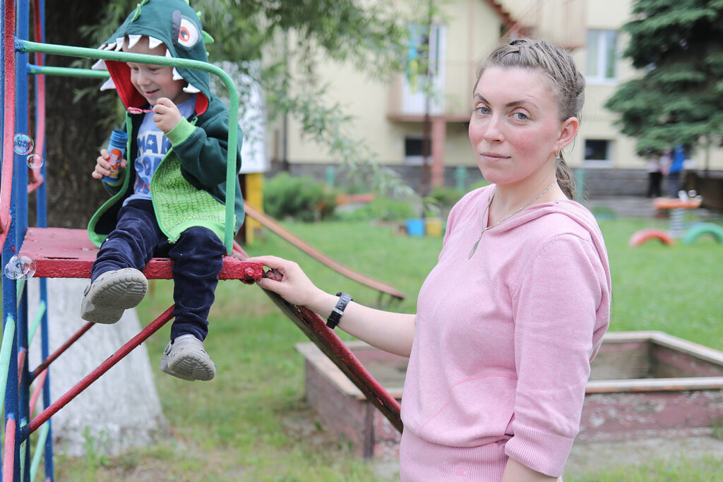 Woman and son play at the park