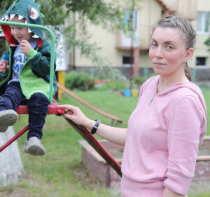 Woman and son play at the park