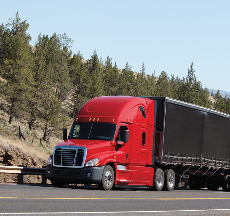 A Daimler truck traveling on a highway.