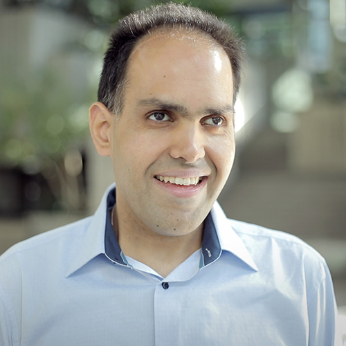 Saqib Shaikh stands in a Microsoft office building lobby