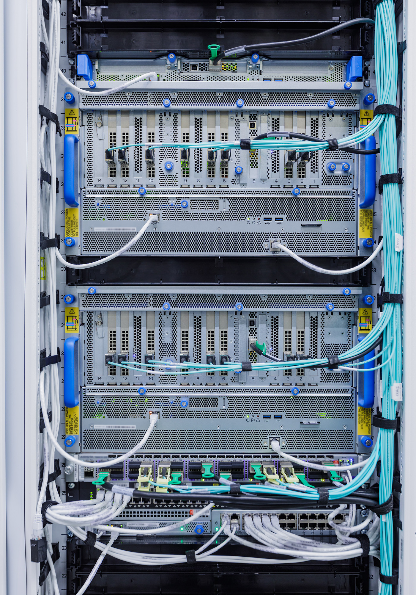 Closeup of a Graphics Processing Unit, known as a GPU, with networking cables attached.