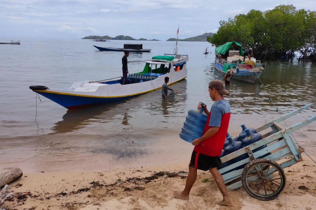 Man carries water to a boat