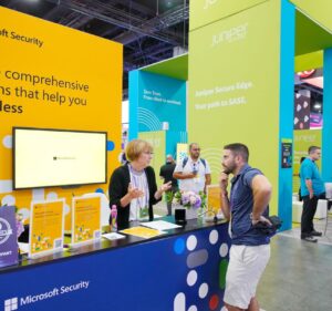 Woman at a Microsoft Security conference booth talks with an attendee