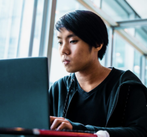 Young man working at a laptop computer