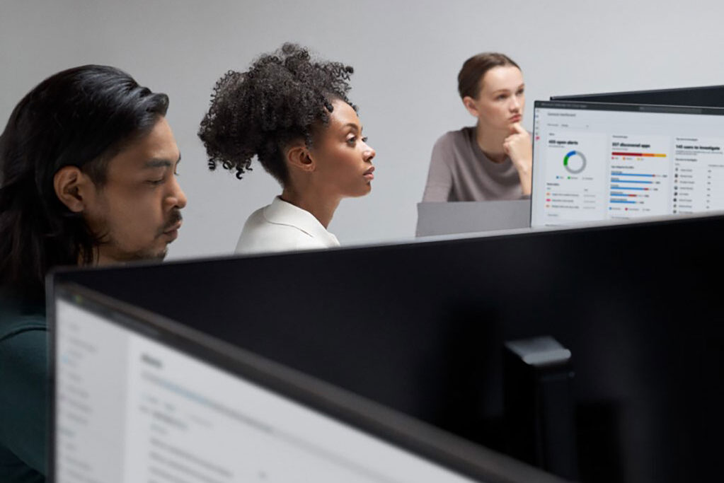 Three people working in an office