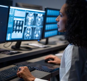 Woman studying computer screen displaying radiology results