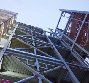 View looking up at a structure with many crossbeams and guardrails