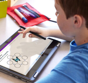 Student working on a tablet computer in a classroom