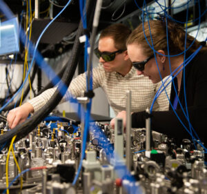 Two Quantinuum scientists working in a lab