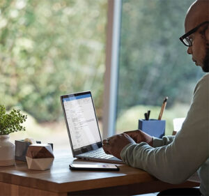 Man in an office working at a laptop computer