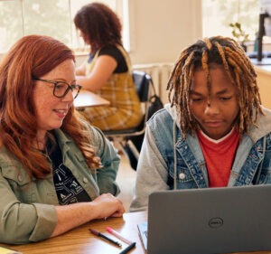 Teacher and student reviewing what's on a laptop comuter