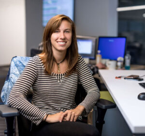 Woman sitting in an office with a desktop compute