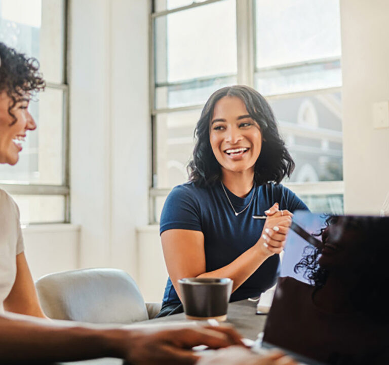 Two women talking at a meeting