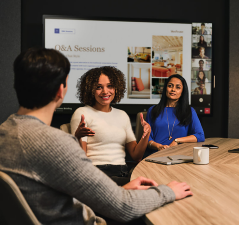 Three people in an office meeting