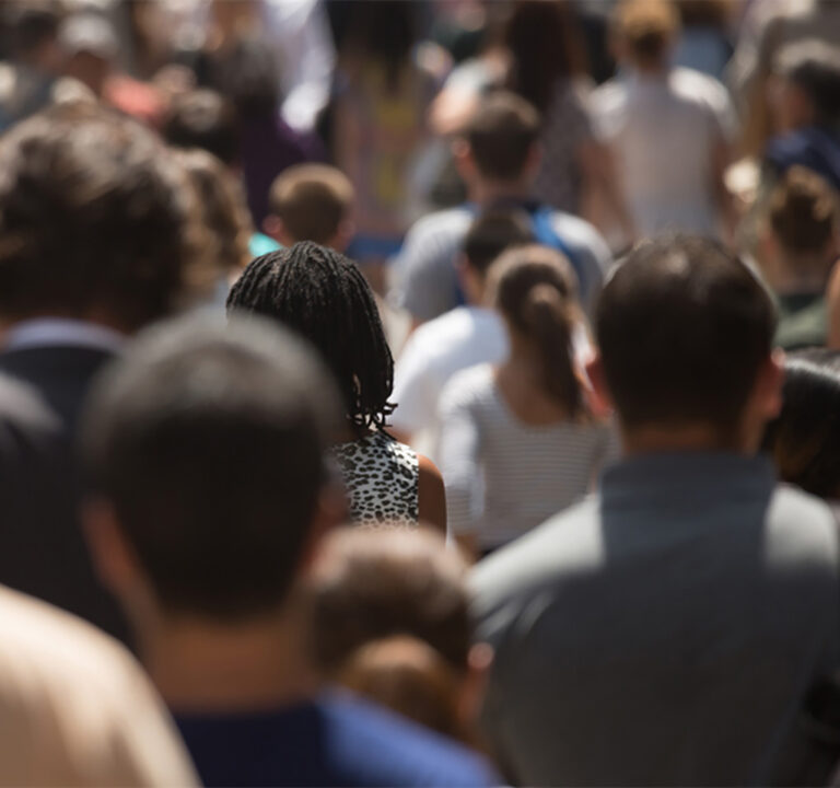 View from behind of a crowd of people walking forward