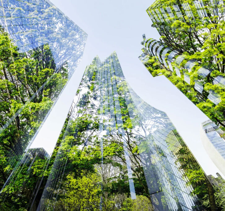 View looking up at skyscrapers with trees projected on them