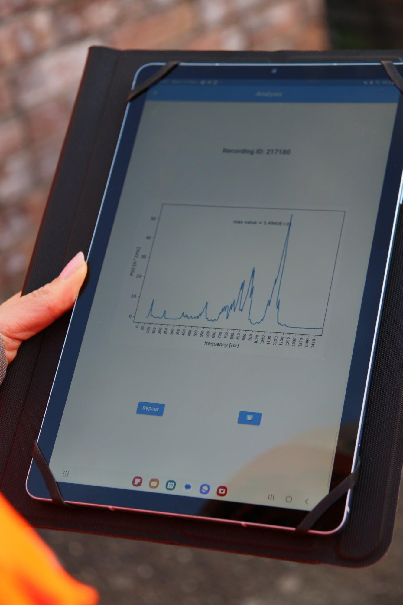 The screen of a tablet device displays a line graph with some extreme peaks.