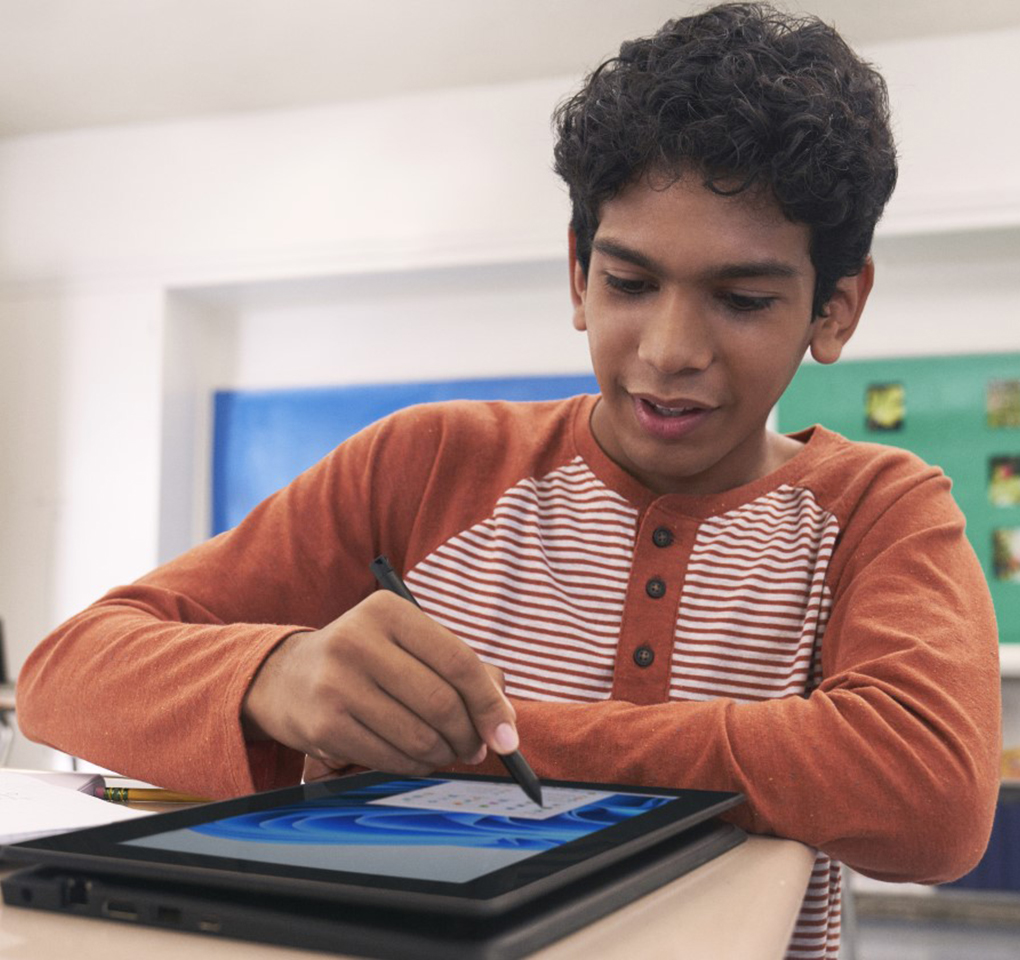 Student interacts with a tablet device in a classroom