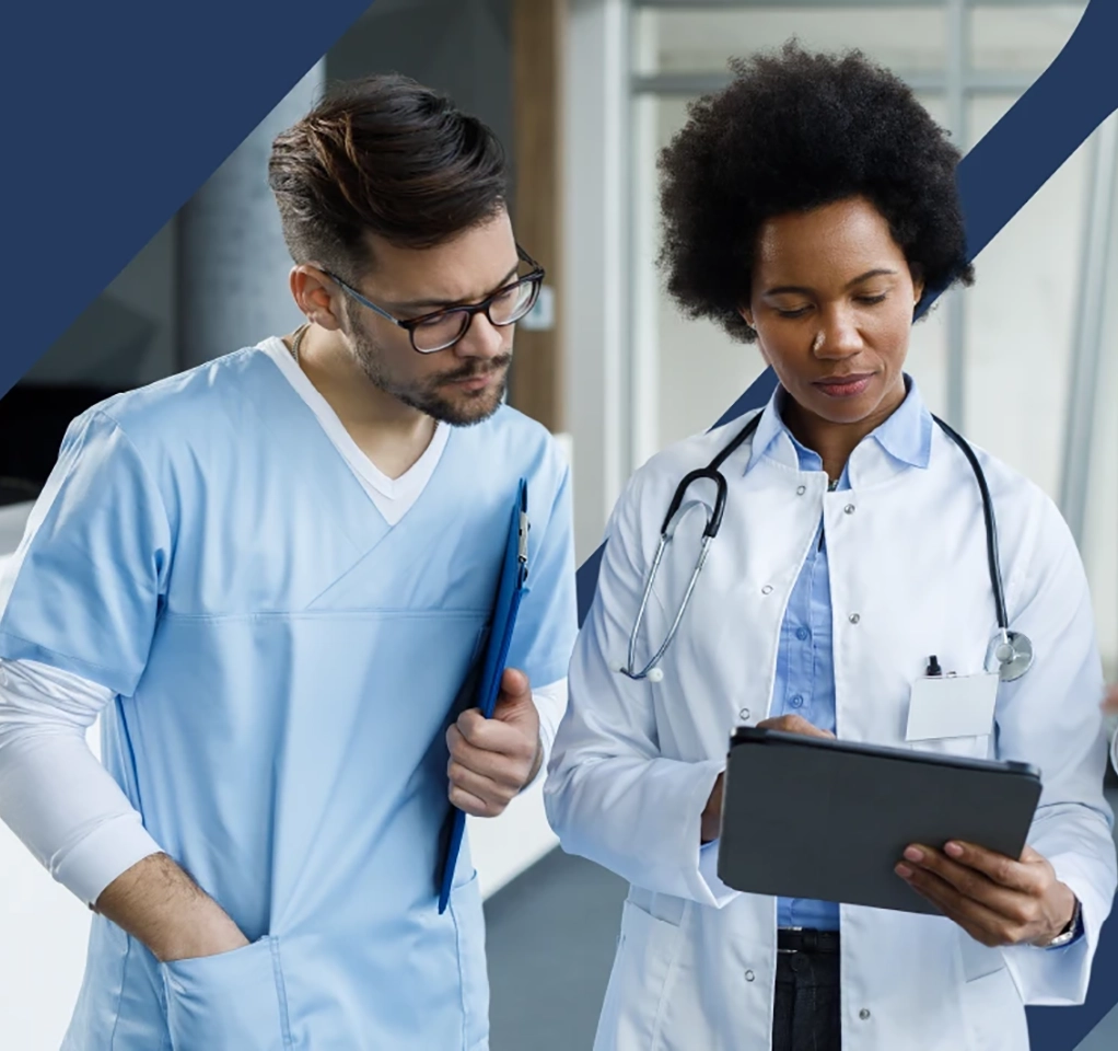 Doctor and nurse look at a health report on a tablet device