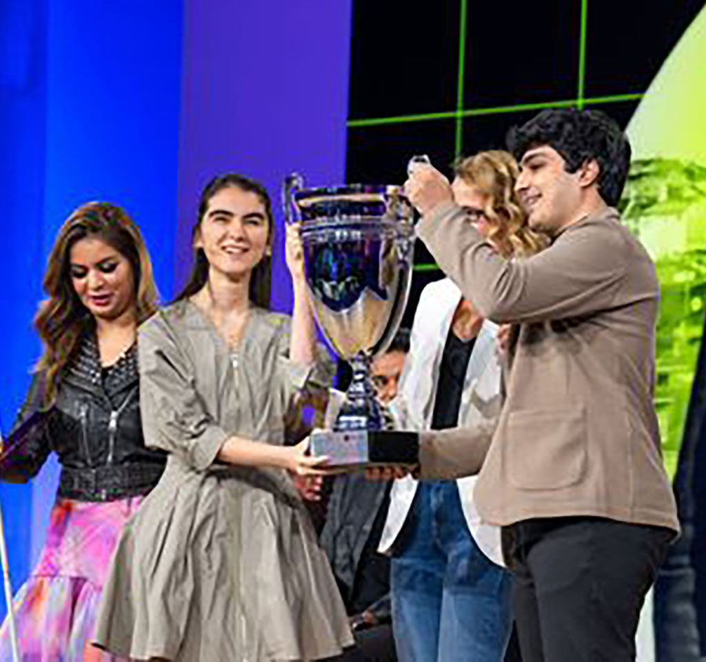 College students holding a trophy