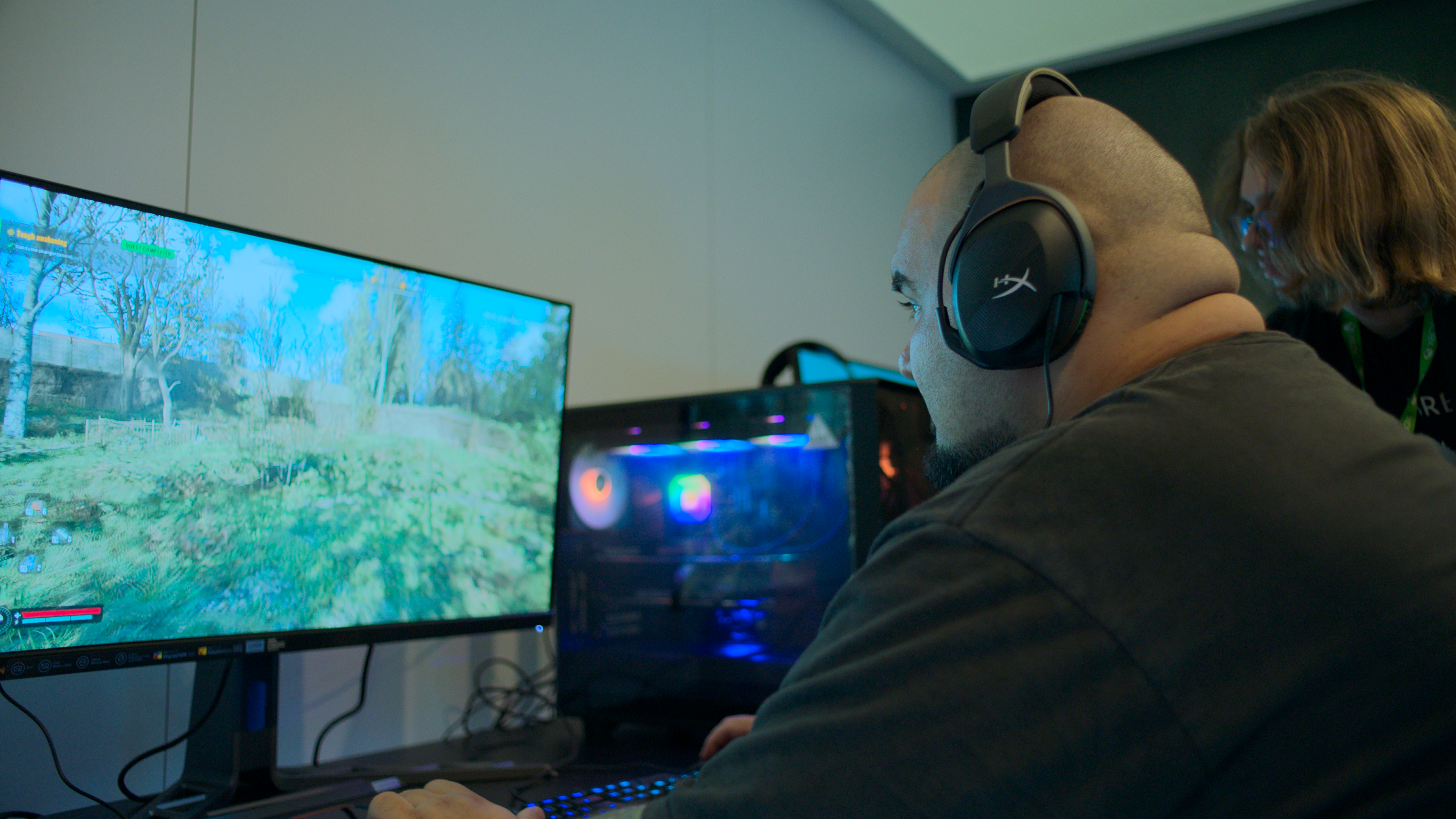 Man sitting in front of PC display with headphones on