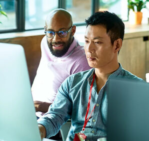 Two men looking at a computer screen at work