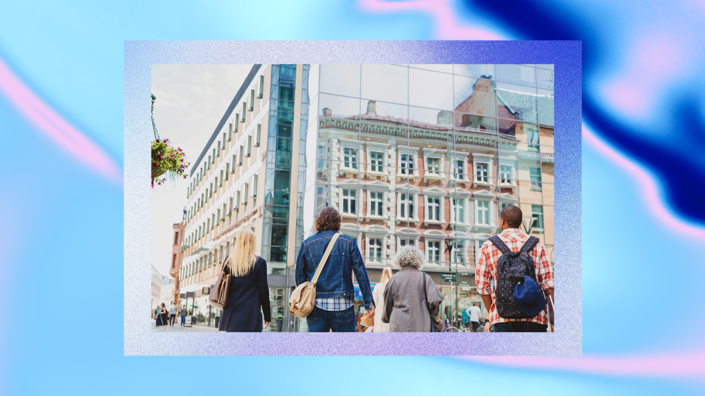 Four people looking up at two European buildings